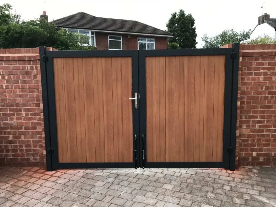 Wood-effect double driveway gates in a black frame
